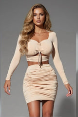 Trendy beige ruched two-piece set with long sleeve crop top and bodycon mini skirt for women
