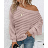 woman wearing a pink off-shoulder ribbed sweater styled with denim for a casual chic look