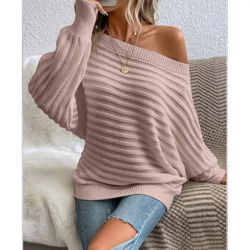 woman wearing a pink off-shoulder ribbed sweater styled with denim for a casual chic look